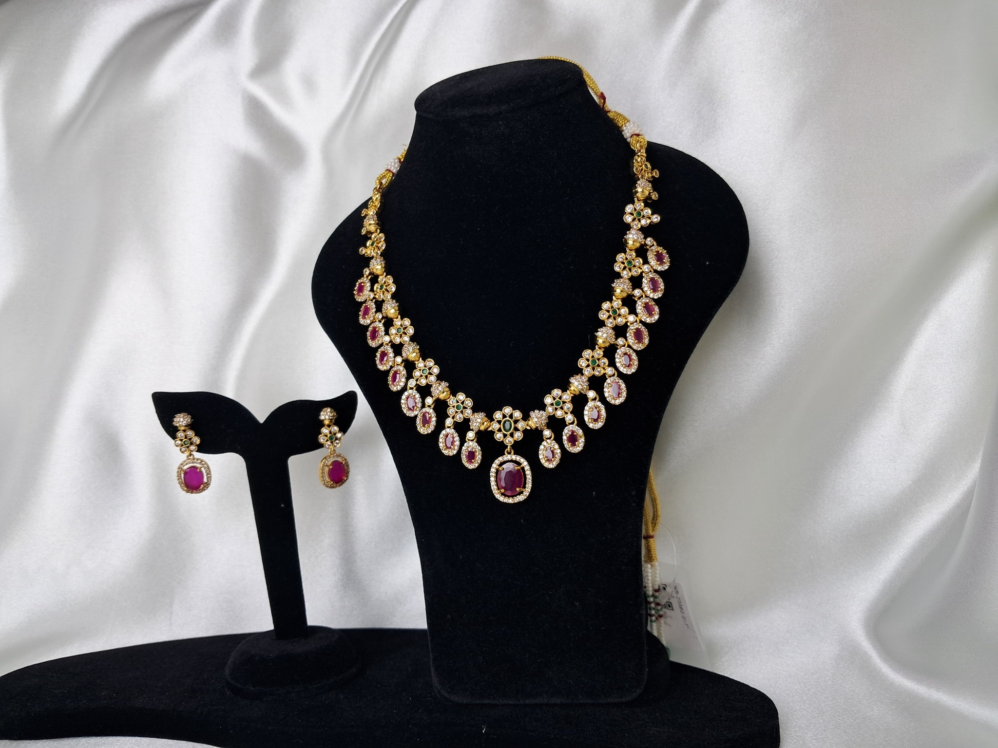 Gold tone statement necklace in green & ruby synthetic stones with matching earrings